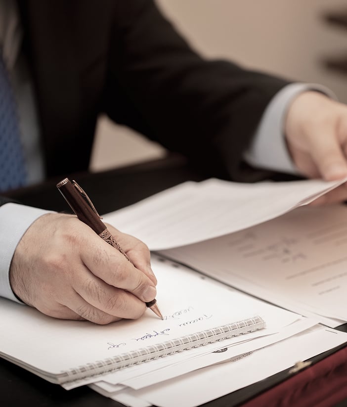 man writing on paper